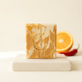 Sweet Orange and Chili Pepper soap with a bright citrus-inspired background