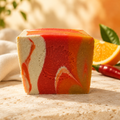 Sweet Orange & Chili Pepper soap with a citrus-inspired background